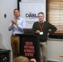 Geoff Southwell presenting at lectern with auslan interpreter